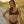 Load image into Gallery viewer, Woman on beach wearing a Bambina Swim black two piece bikini, ring detail, adjustable straps, tie back, high cut leg bottom

