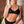 Load image into Gallery viewer, Woman wearing a Bambina Swim black two piece swimsuit. Ring detail on strap, tie back, mid coverage bottom, high cut leg.
