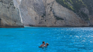 Man and woman in deep blue water in Zakynthos Greece