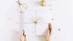 White gift box with gold bow