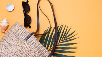 Straw beach bag, sunglasses, and seashells