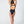 Load image into Gallery viewer, Back view of a women wearing a black one piece swimsuit
