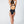 Load image into Gallery viewer, Back view of a women wearing a black one piece swimsuit
