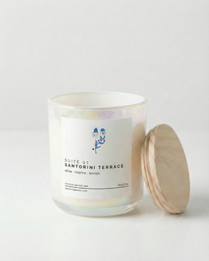 Candle with a label and wooden lid on a light gray background