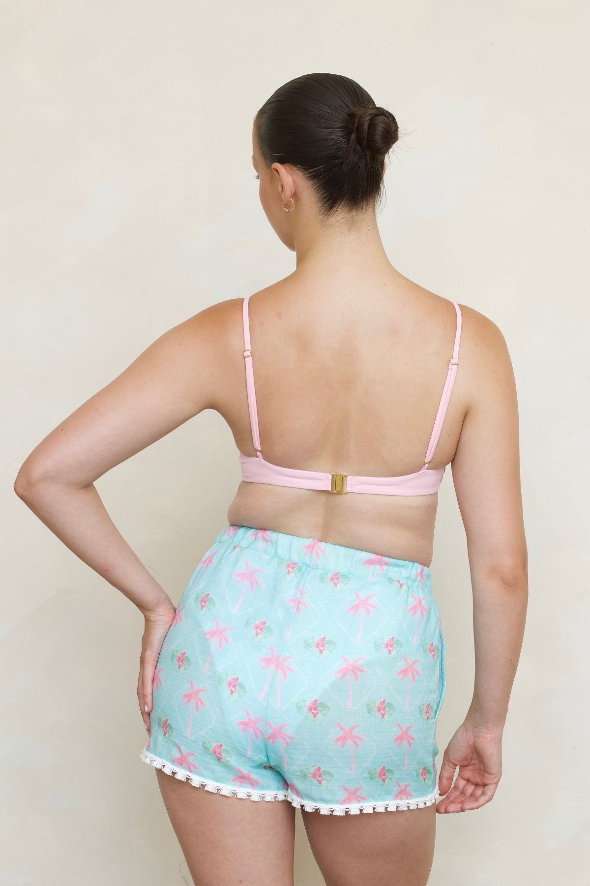 Rebecca Shorts in Cayman print, back view on model showing elastic waistband, side pockets, and tassel trim.