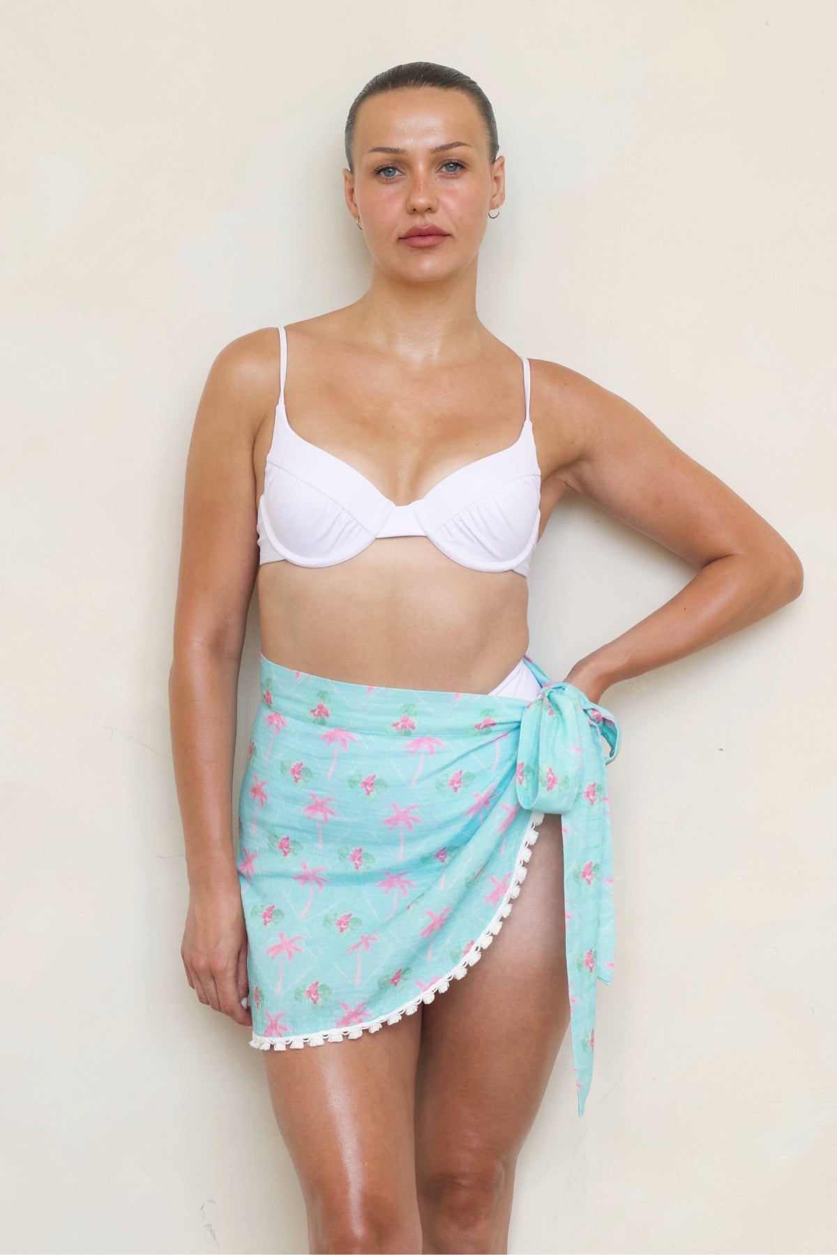Savannah Mini Sarong in Cayman Print front view on model showing side -tie wrap and white tassel trim.