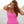 Load image into Gallery viewer, Woman on beach wearing a bright pink one piece bathing suit.
