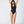 Load image into Gallery viewer, Woman standing with arms over her head wearing a black one piece bathing suit. 
