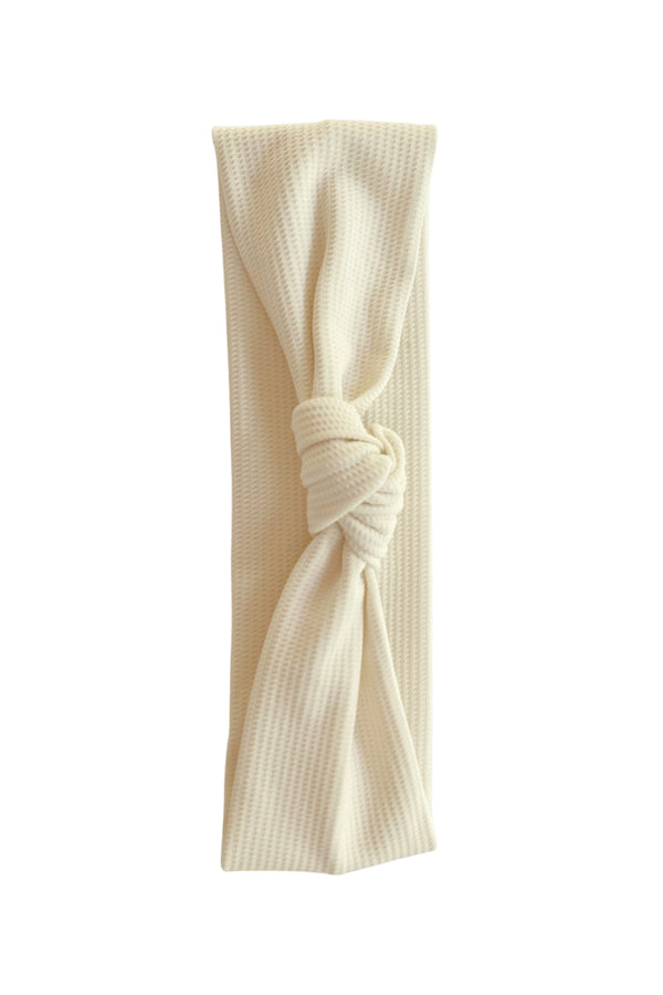 Ivory colored headband with knot on top.