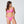 Load image into Gallery viewer, Woman standing wearing a pink bikini. Ring detail on strap, mid coverage bottom, high cut leg.
