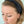 Woman wearing black headband with knot on top.